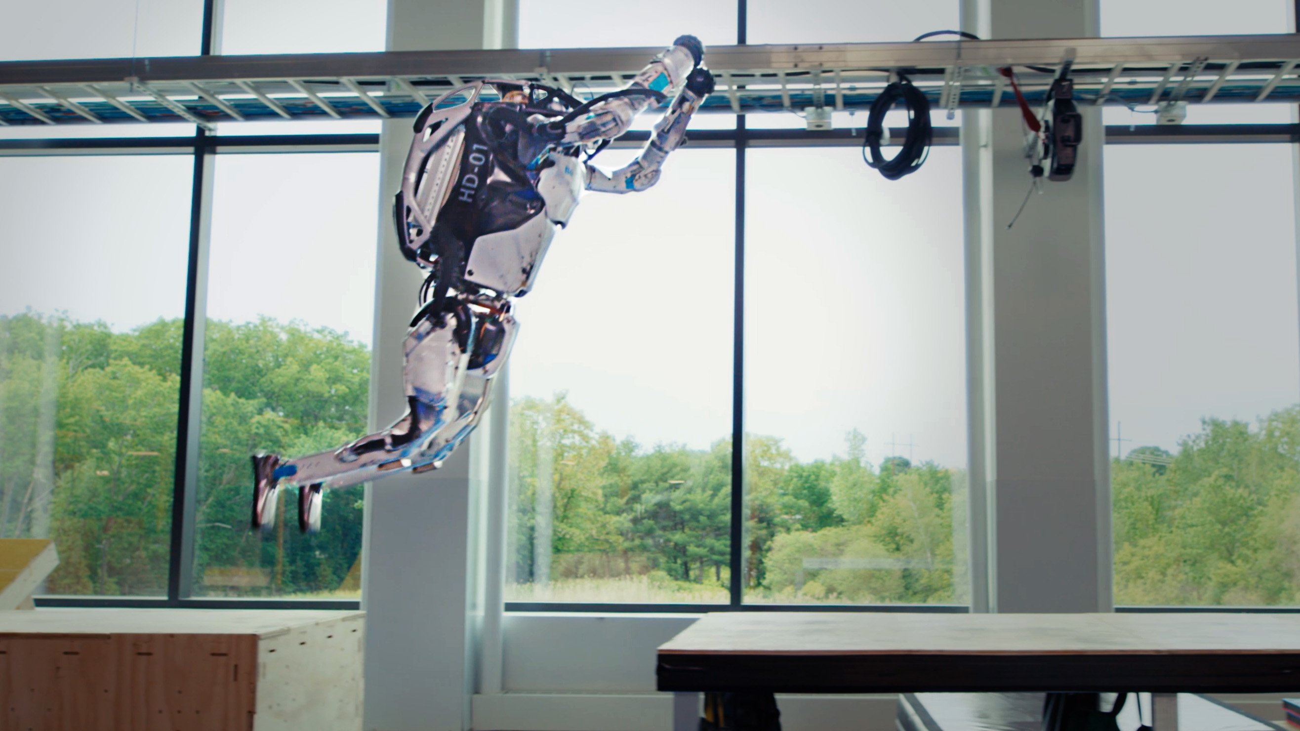 Atlas jumps between boxes in the Boston Dynamics lab.